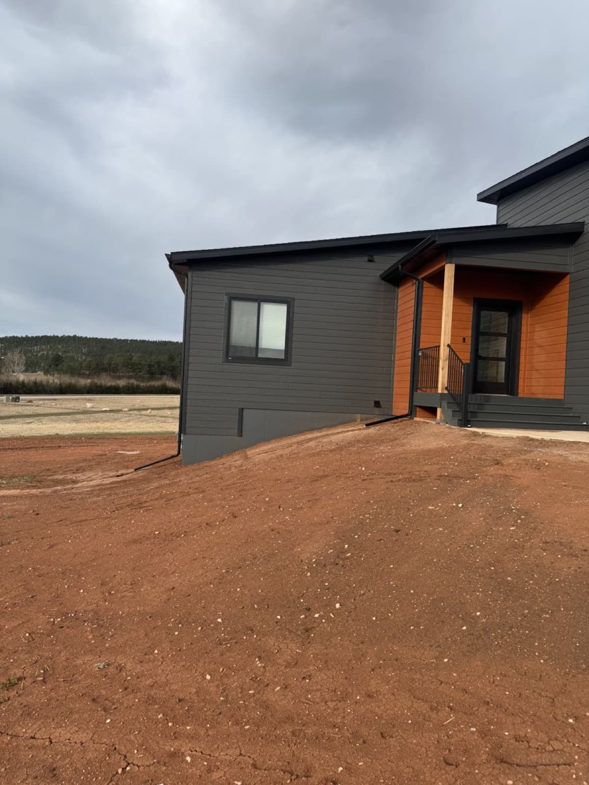 Raw dirt lot at new construction site before grading and landscaping