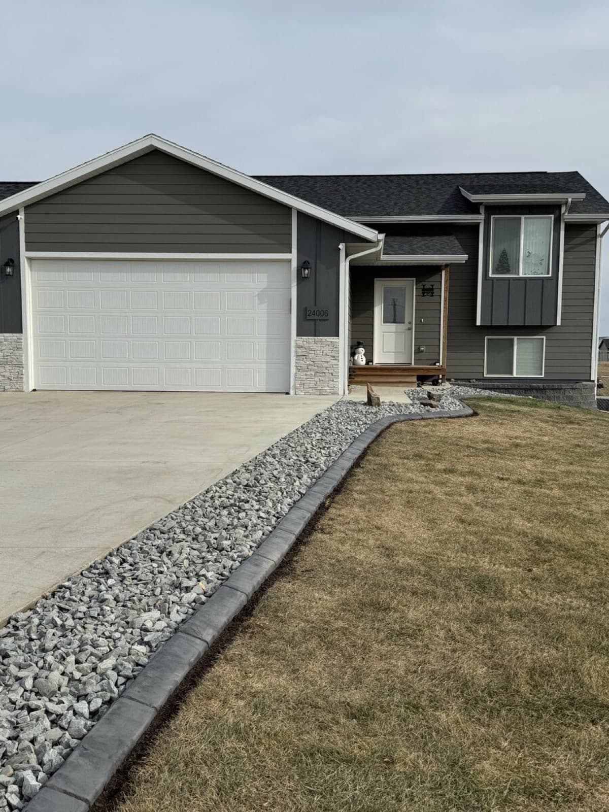 Finished rock border with curbing around entire home perimeter
