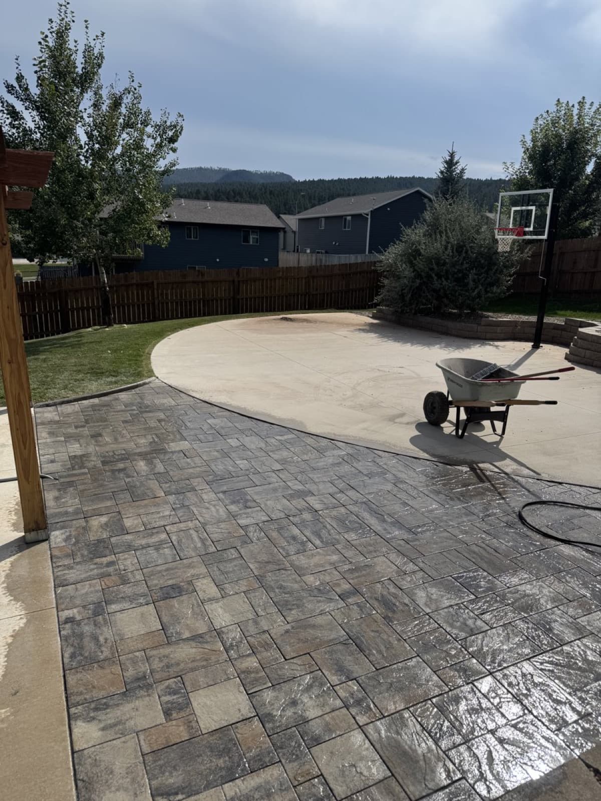 Paver patio with pergola structure in a Rapid City backyard