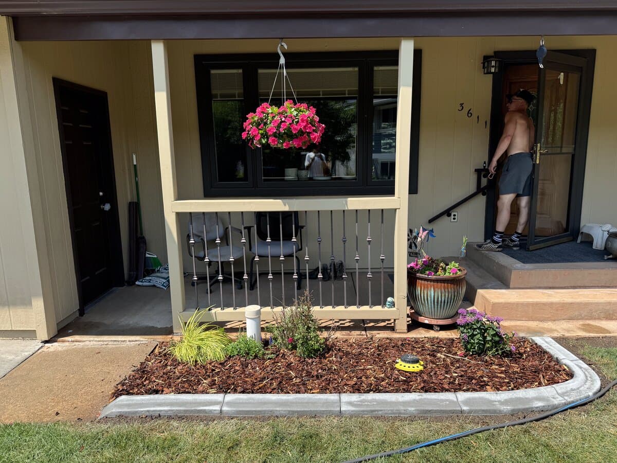 Professional garden bed installation with shrubs, perennials, and mulch