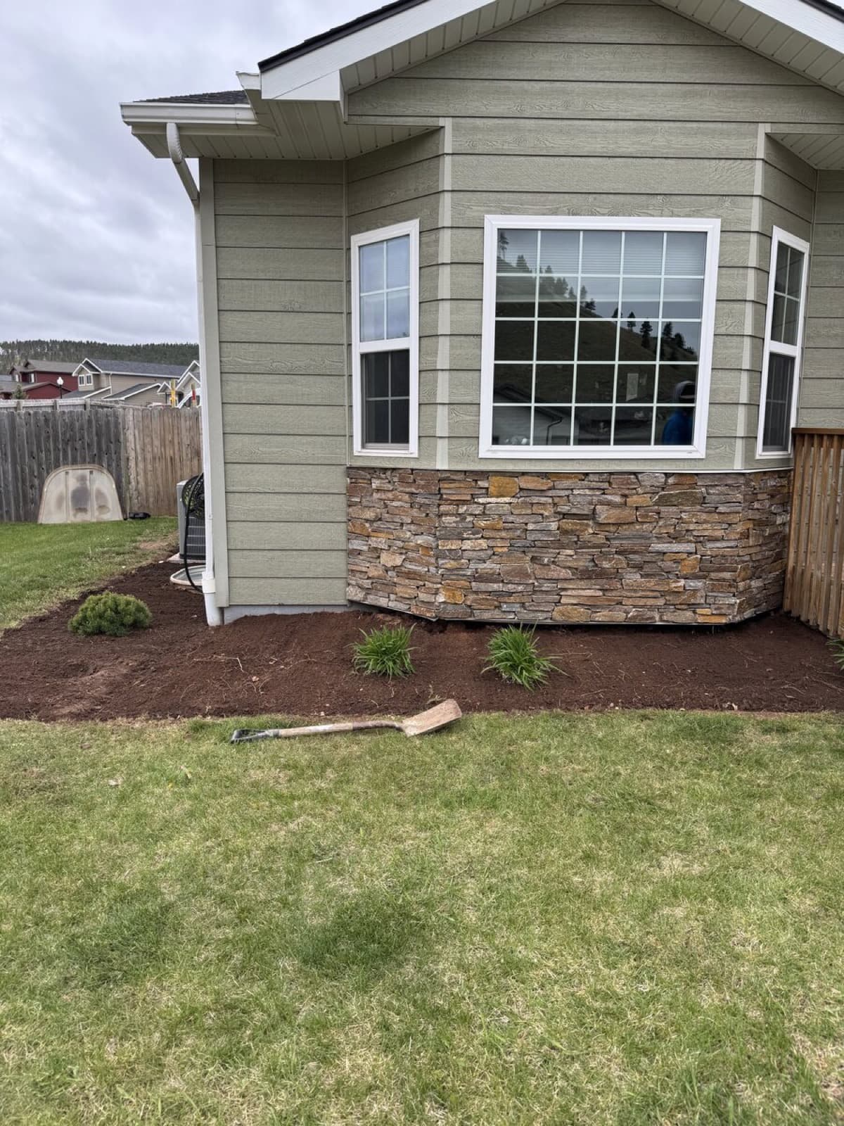 Mulch bed installation with ornamental plants and clean landscape borders