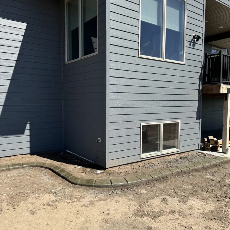 Fresh concrete curbing installed at new construction site by ATK Landscaping in the Black Hills