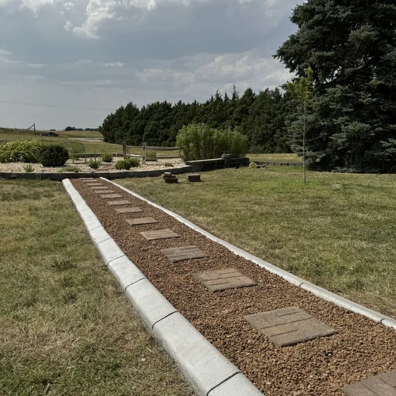 Stepping stone walkway with curbing borders built by ATK Landscaping